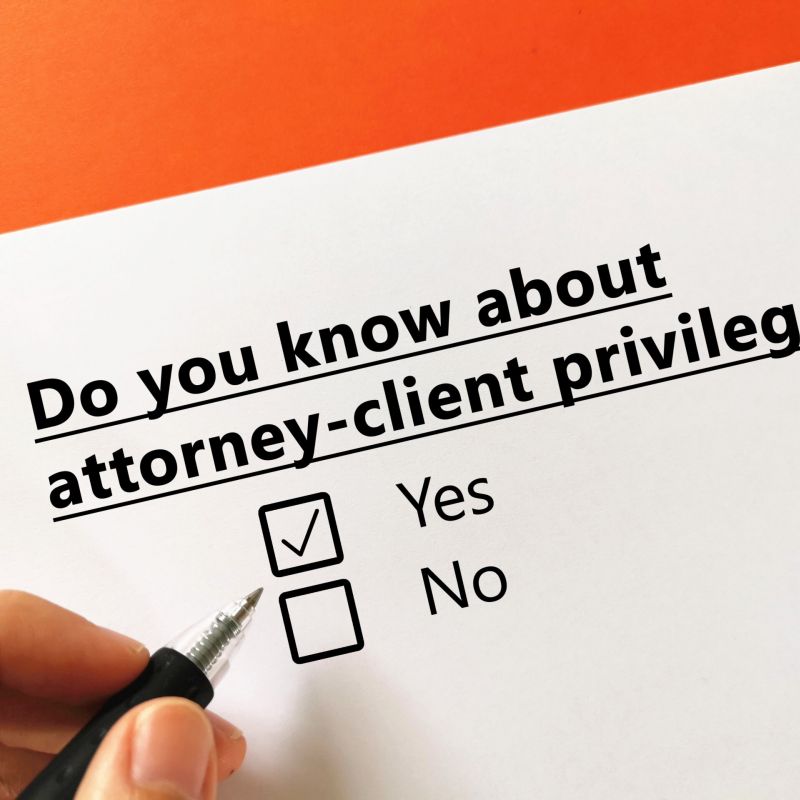 Paper and pen with question about attorney-client privilege and yes/no checkboxes
