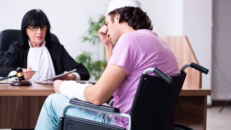 a woman sitting in a wheel chair next to a man in a wheelchair
