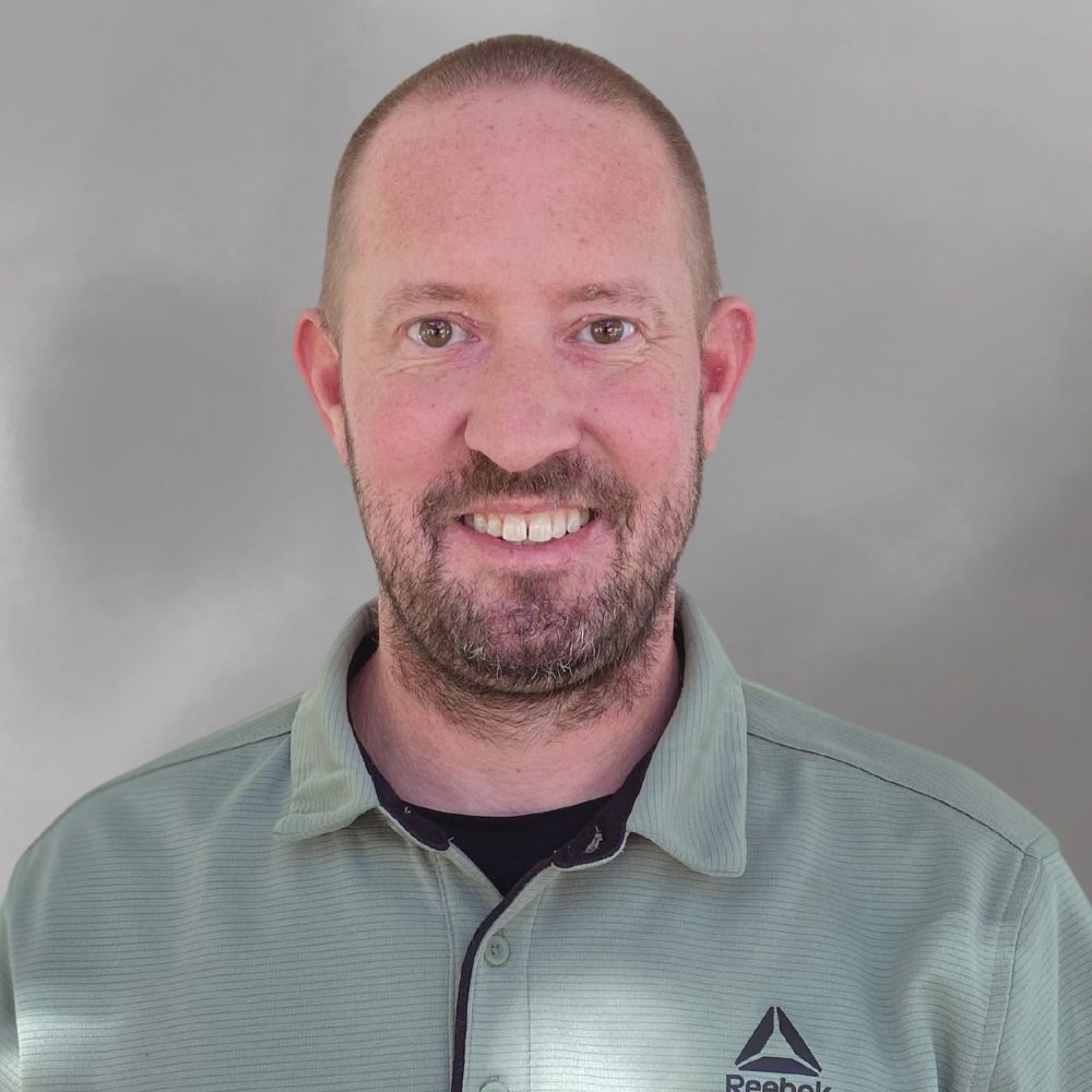 Matthew Spencer in green Reebok shirt against a plain background.