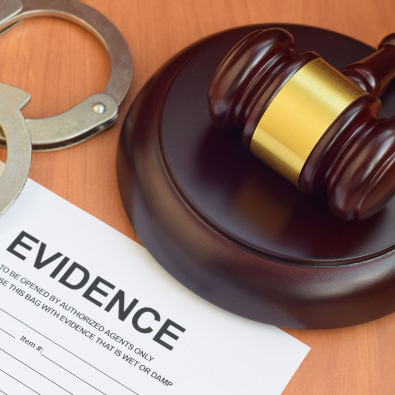 Justice mallet and evidence report blank document for investigation with police handcuffs
