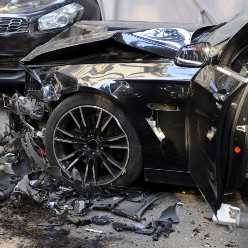 Black mustang with front end damage from a car accident