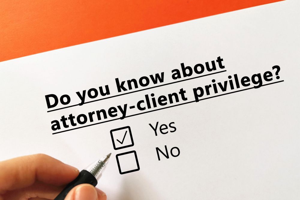 Paper and pen with question about attorney-client privilege and yes/no checkboxes