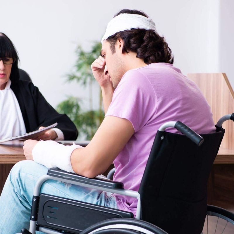 a woman sitting in a wheel chair next to a man in a wheelchair