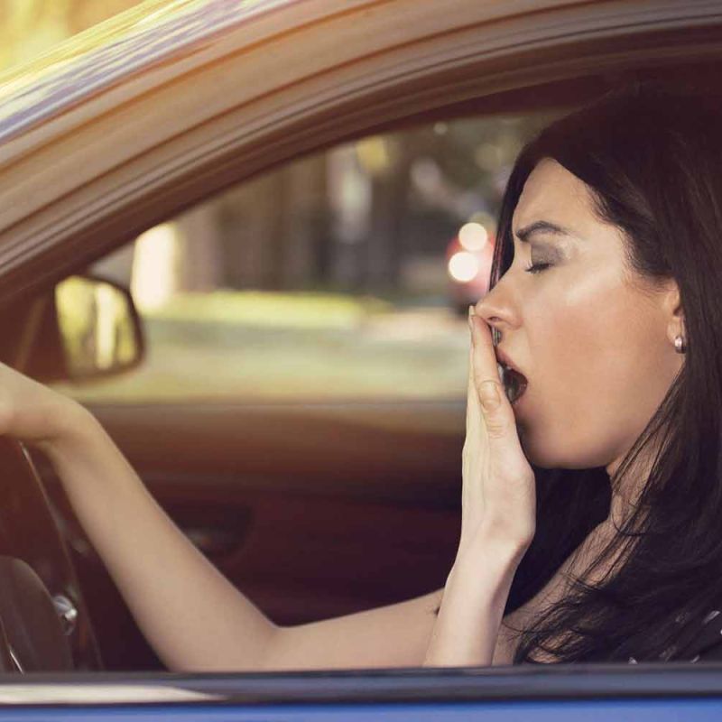 awning woman driving her car after losing an hour of sleep due to DST