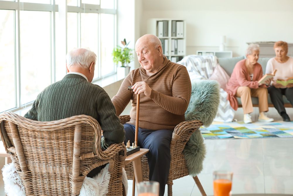 Doctor and elderly man using a walker taking a walk in a nursing home