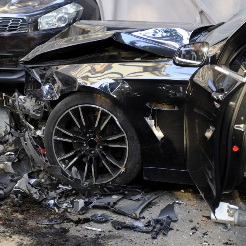 Black mustang with front end damage from a car accident