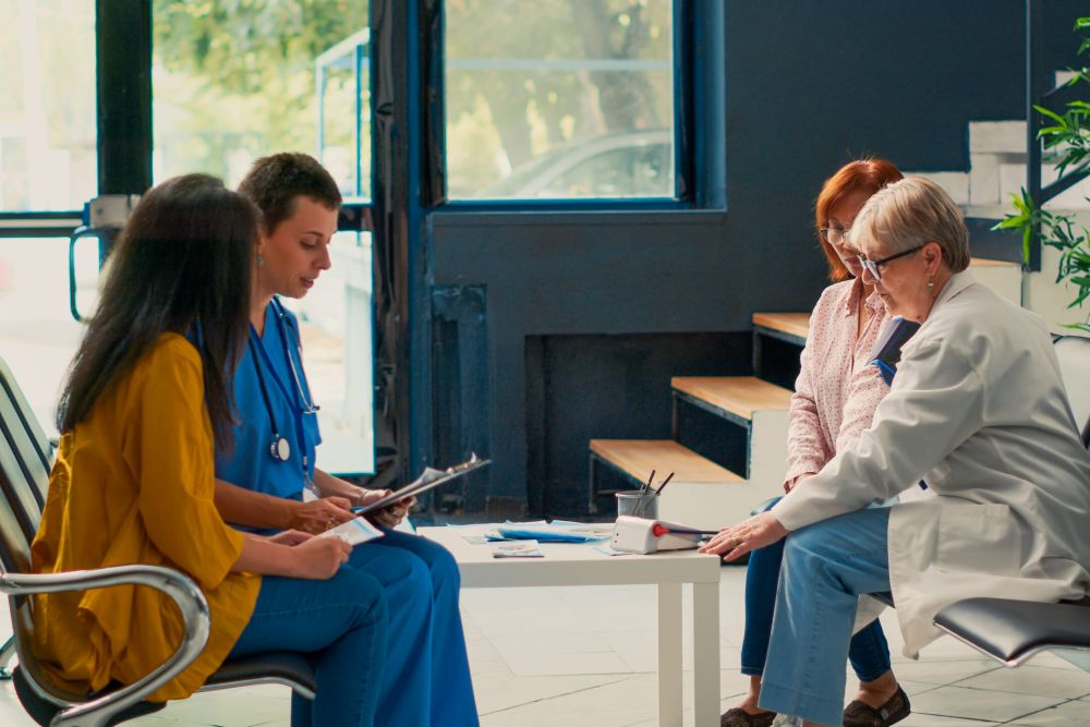 Family and medical staff reviewing care documents; Williams DeLoatche urges preserving nursing home evidence for legal cases.