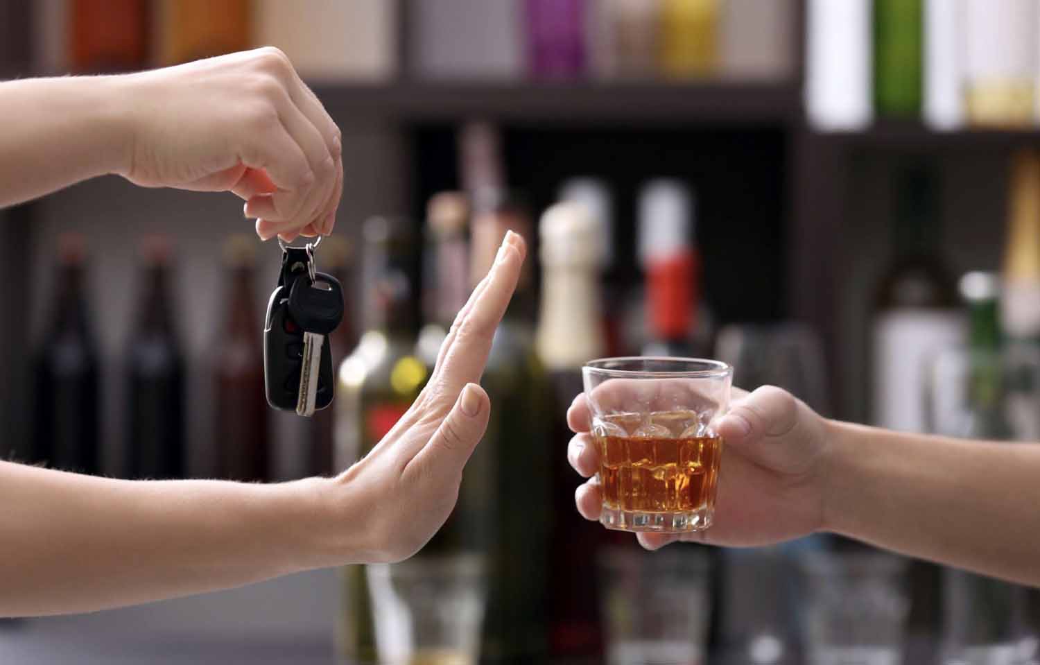 Teen driver with car key refusing an alcoholic beverage.