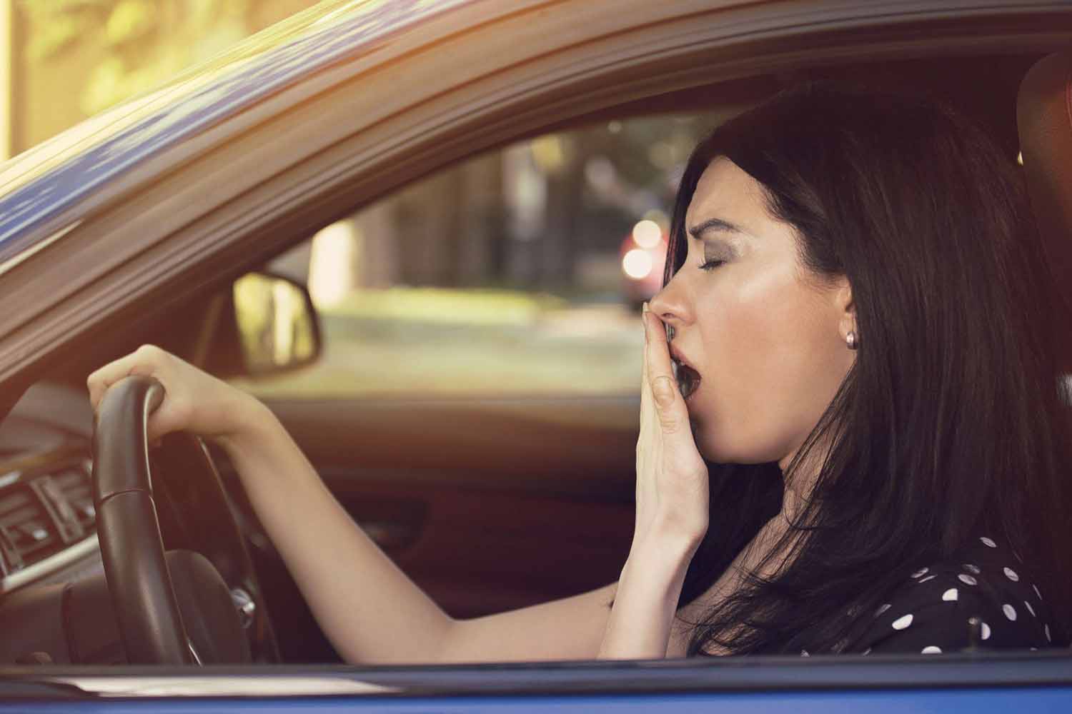 awning woman driving her car after losing an hour of sleep due to DST