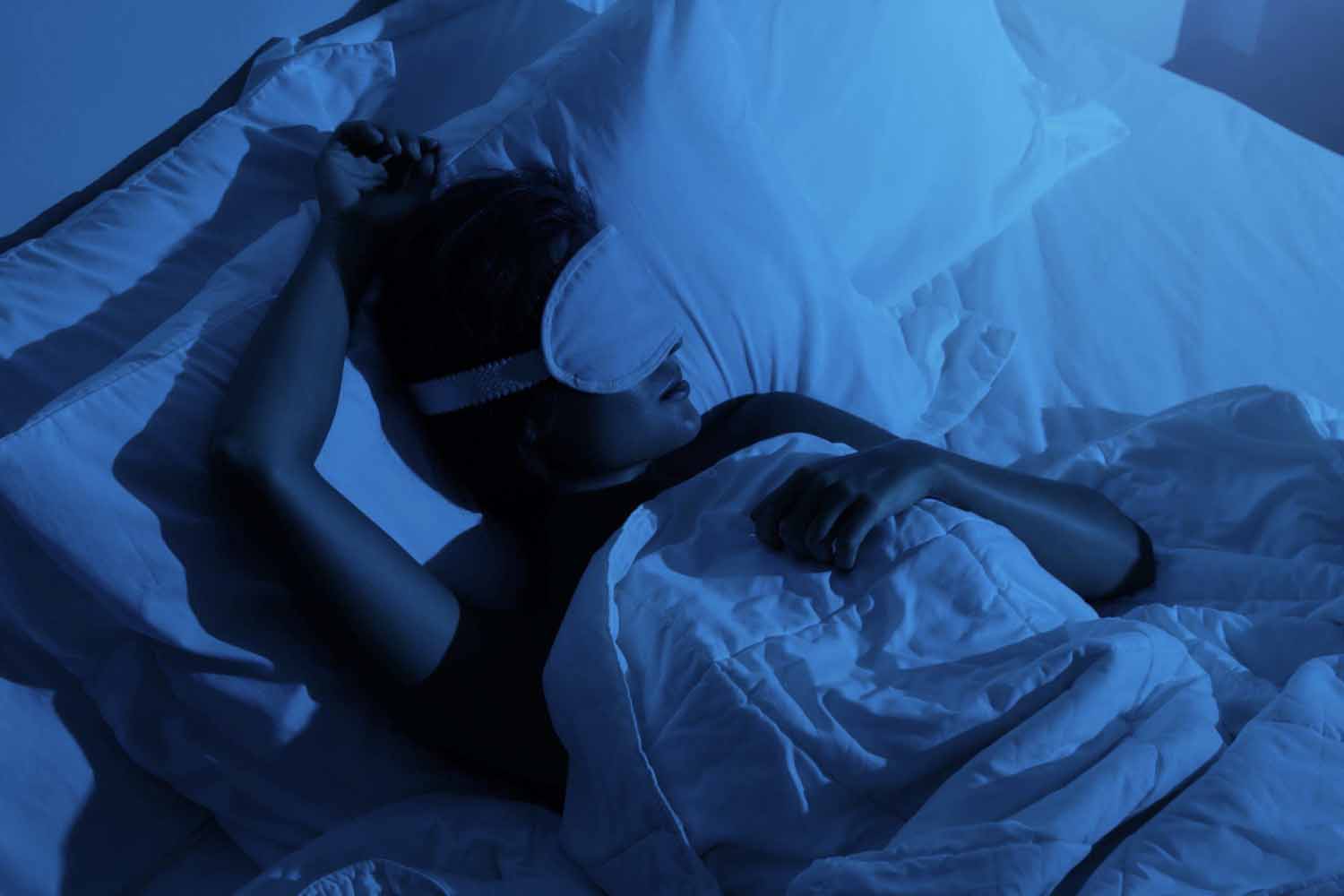 Woman sleeping with a sleep mask on her eyes