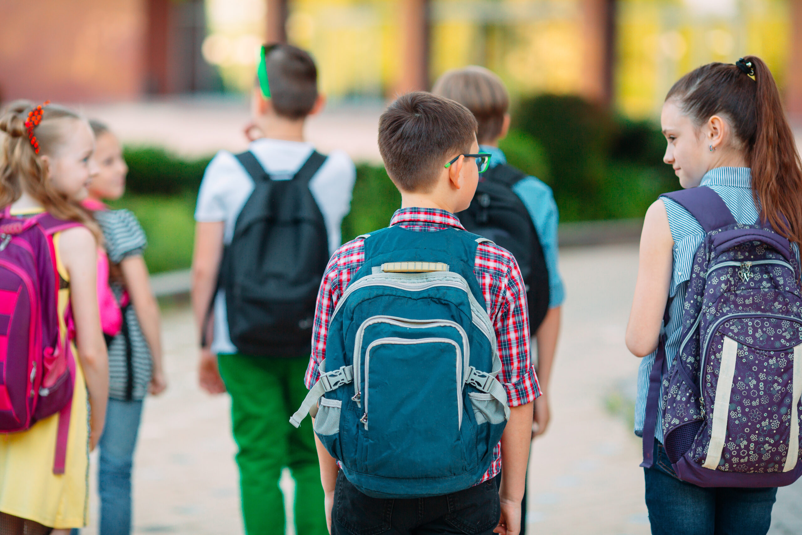 Group of kids going to school together wearing proper fitting backpacks