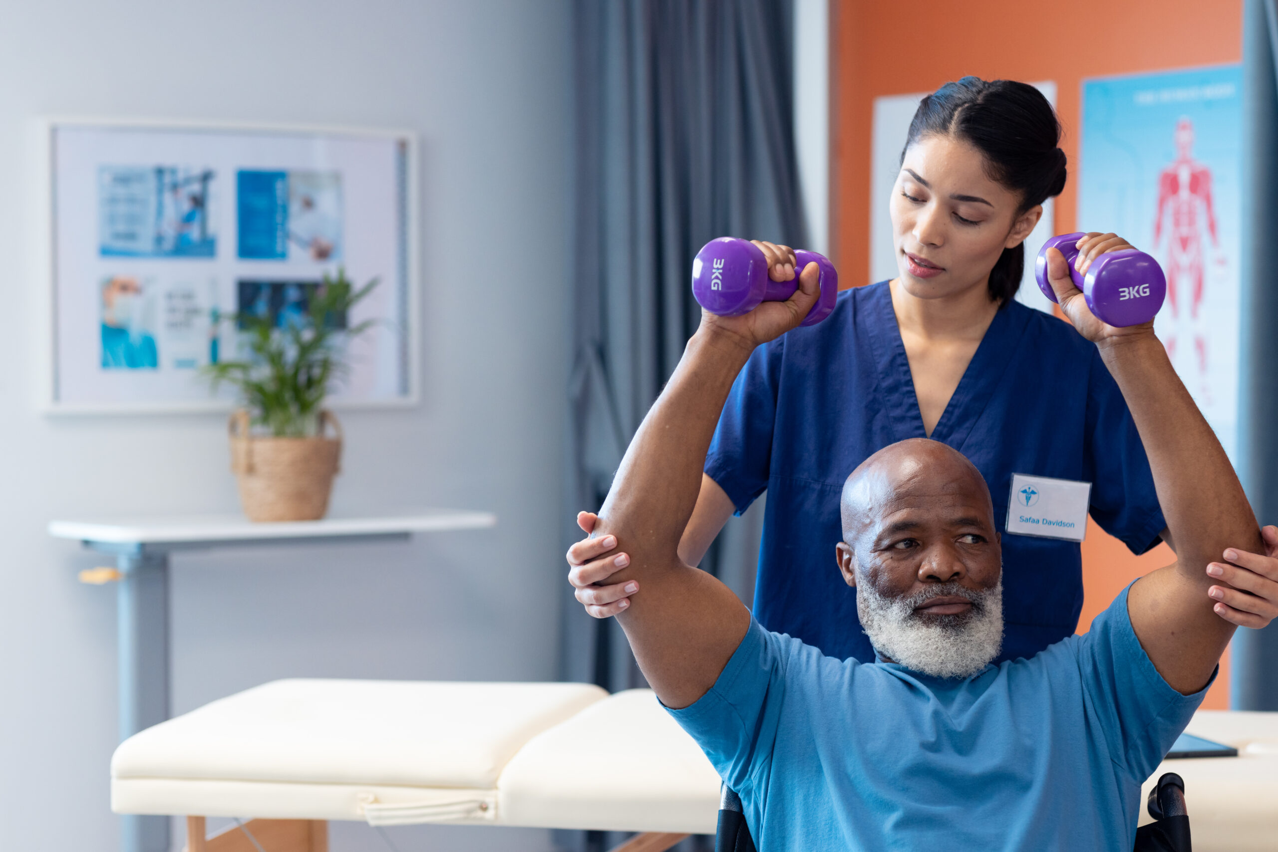 Physical therapist assisting an elderly man in a wheelchair with strength exercises, illustrating the connection between physical therapy and personal injury claims.