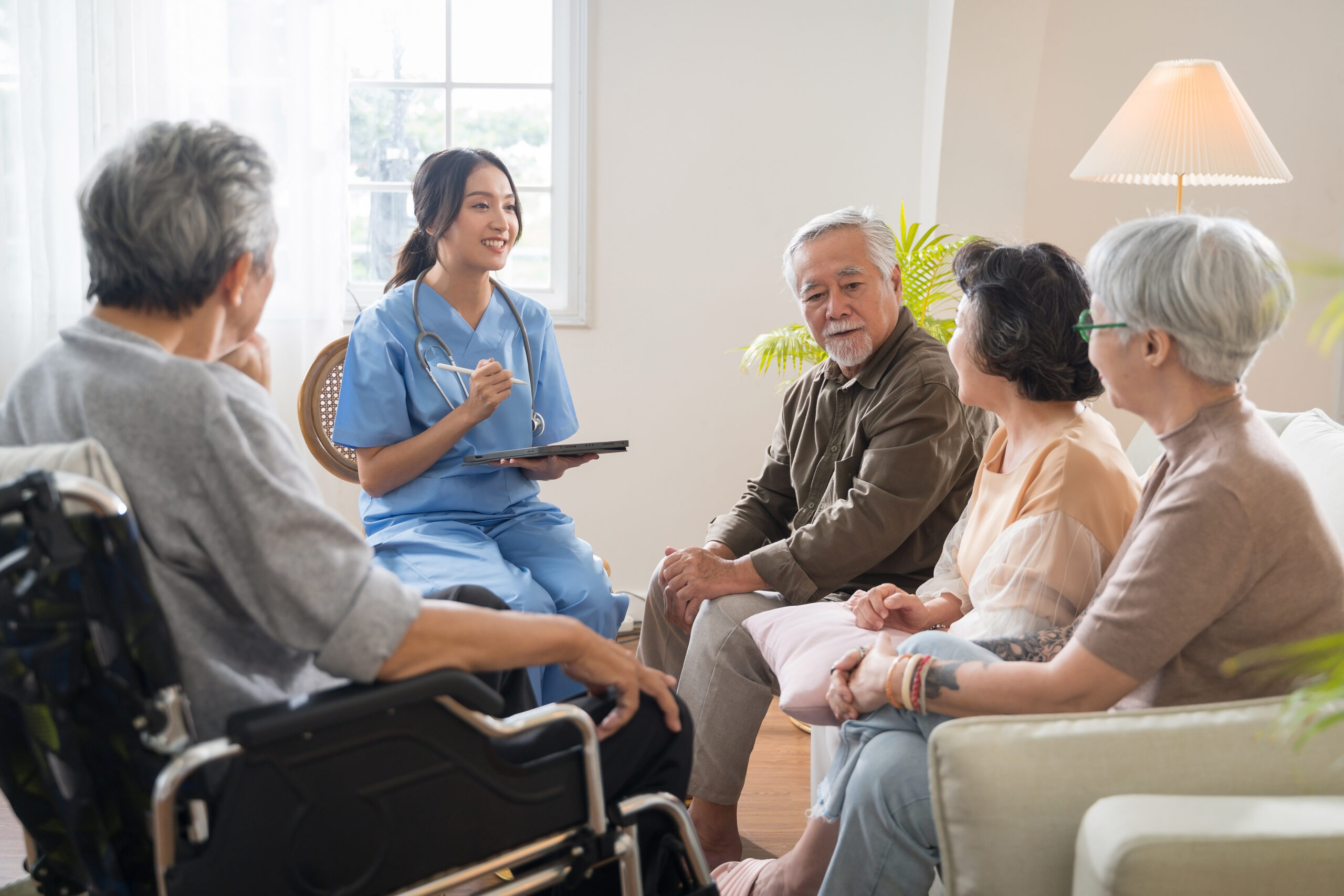 Nurse consulting with a group of elderly individuals, highlighting the importance of knowledge and awareness in making informed healthcare decisions.