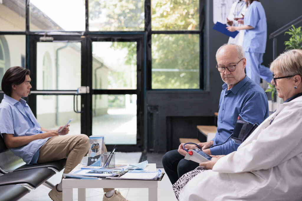 Doctor checks blood pressure of elderly man while caregiver observes; Williams DeLoatche emphasizes medical evidence in abuse cases.