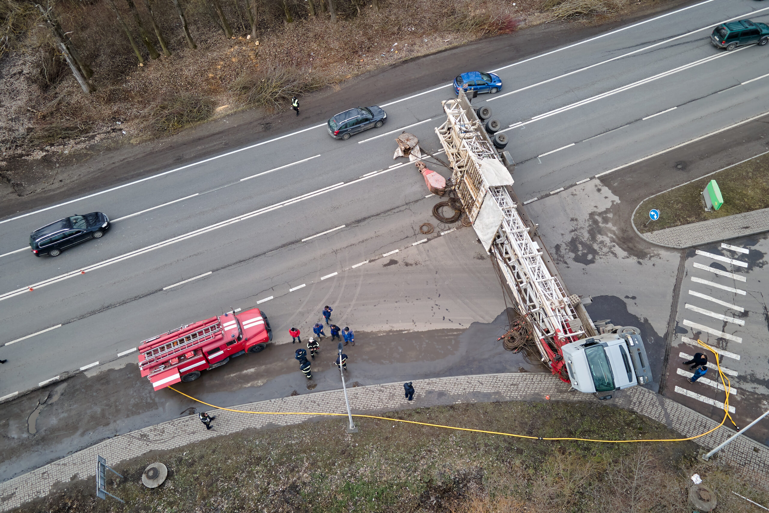 Overturned construction truck at intersection with emergency crews on scene
