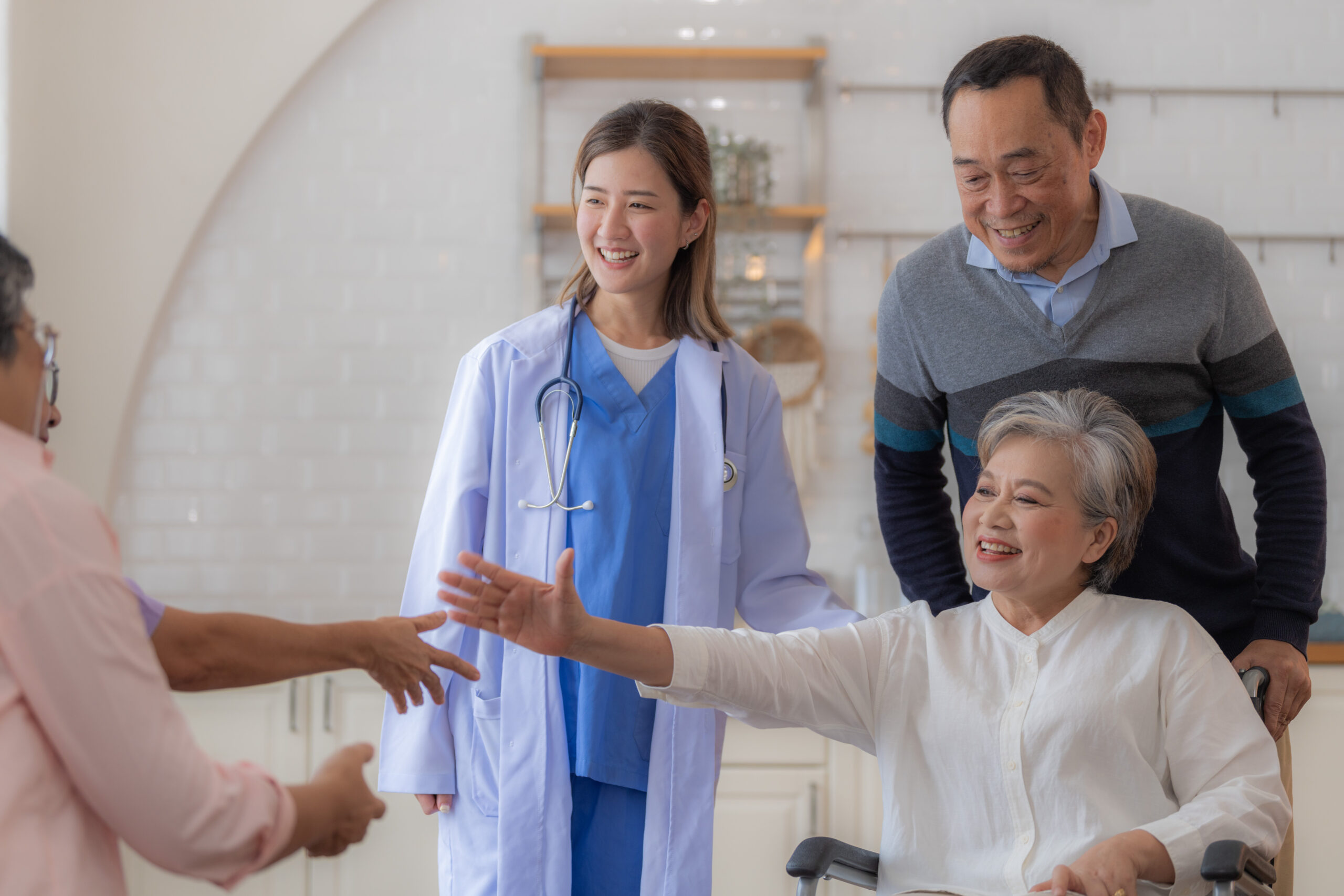 Smiling senior woman in wheelchair with family and doctor, representing positive nursing home care