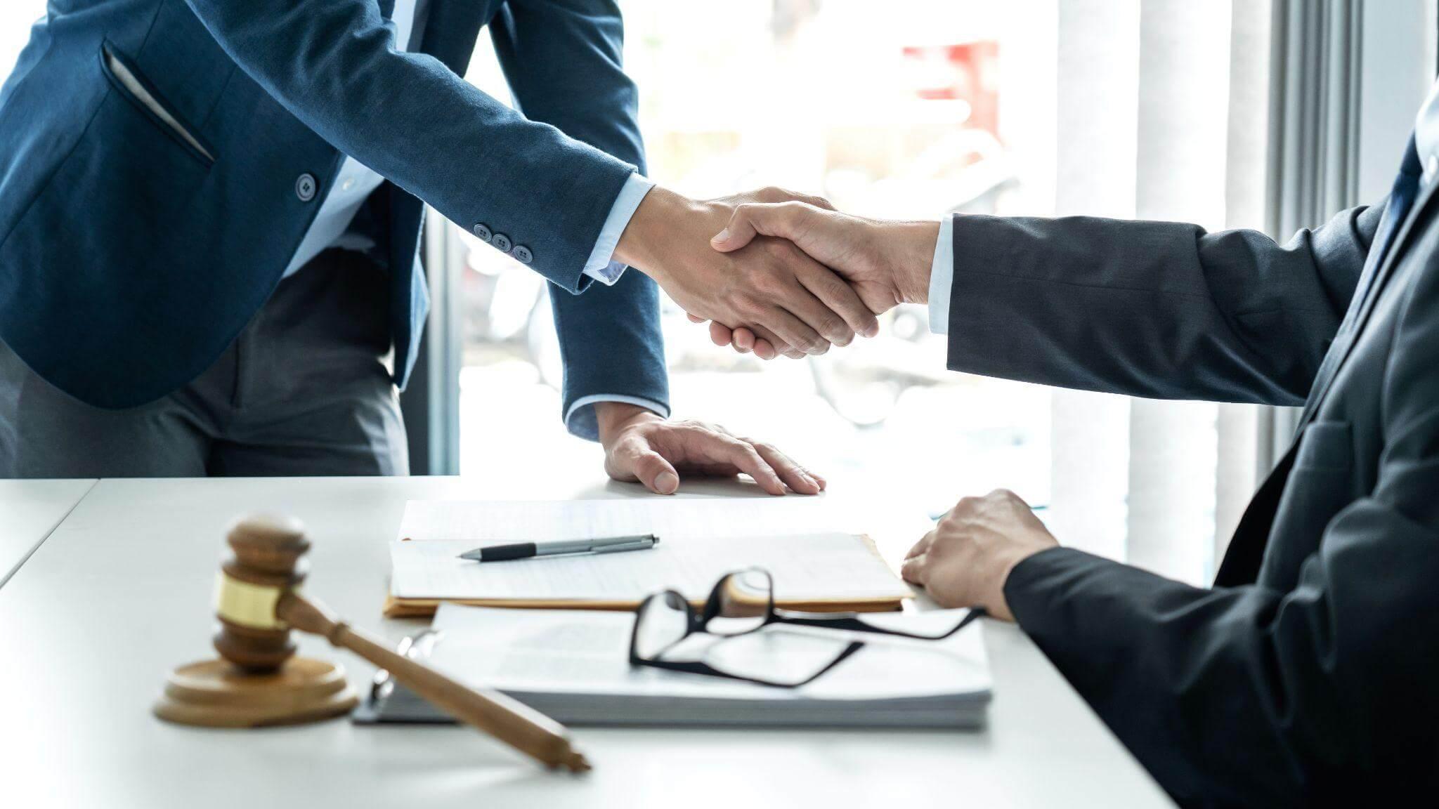 Men shaking hands with judge after pedestrian accident settlement